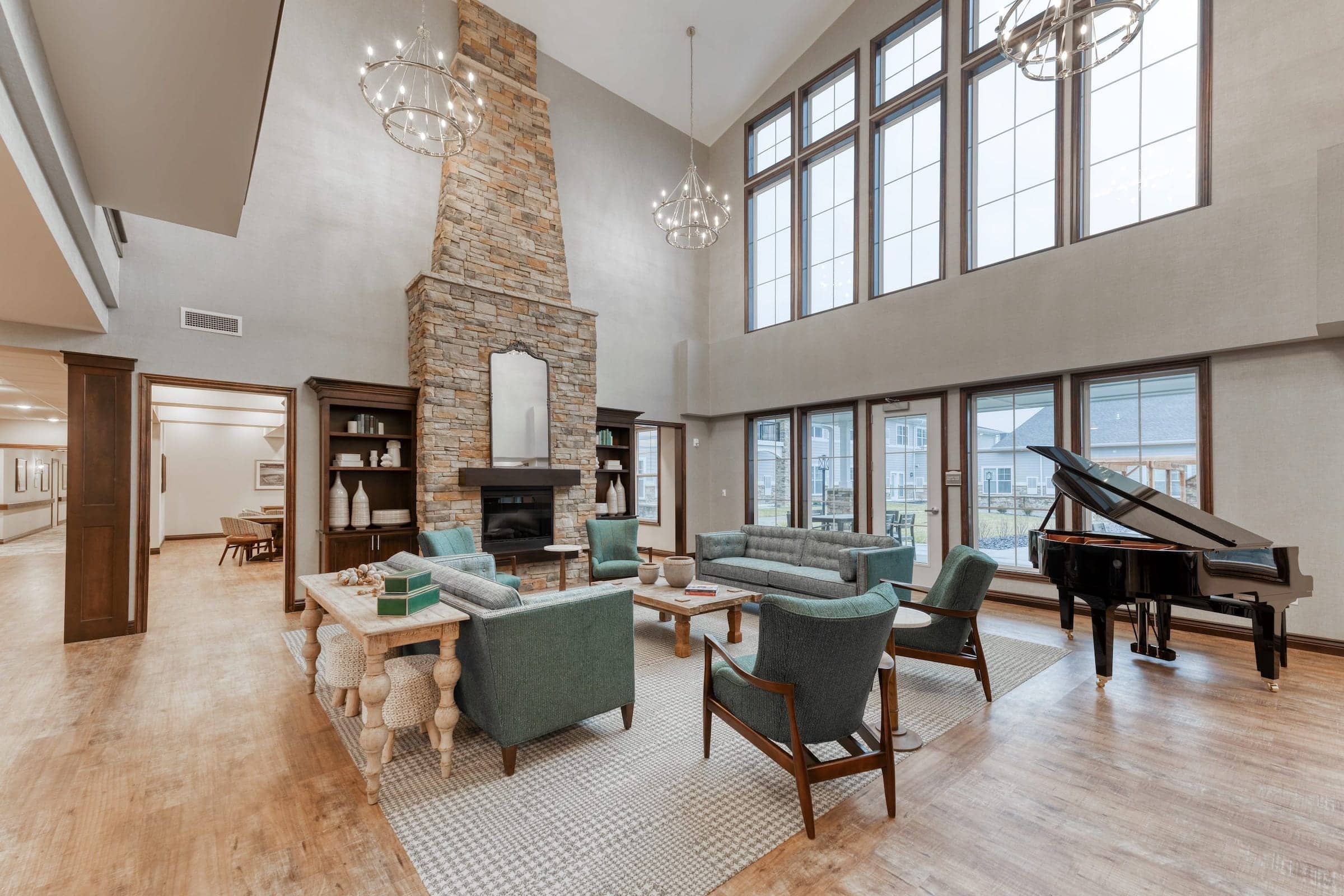 Open community space featuring a stone fireplace and communal piano