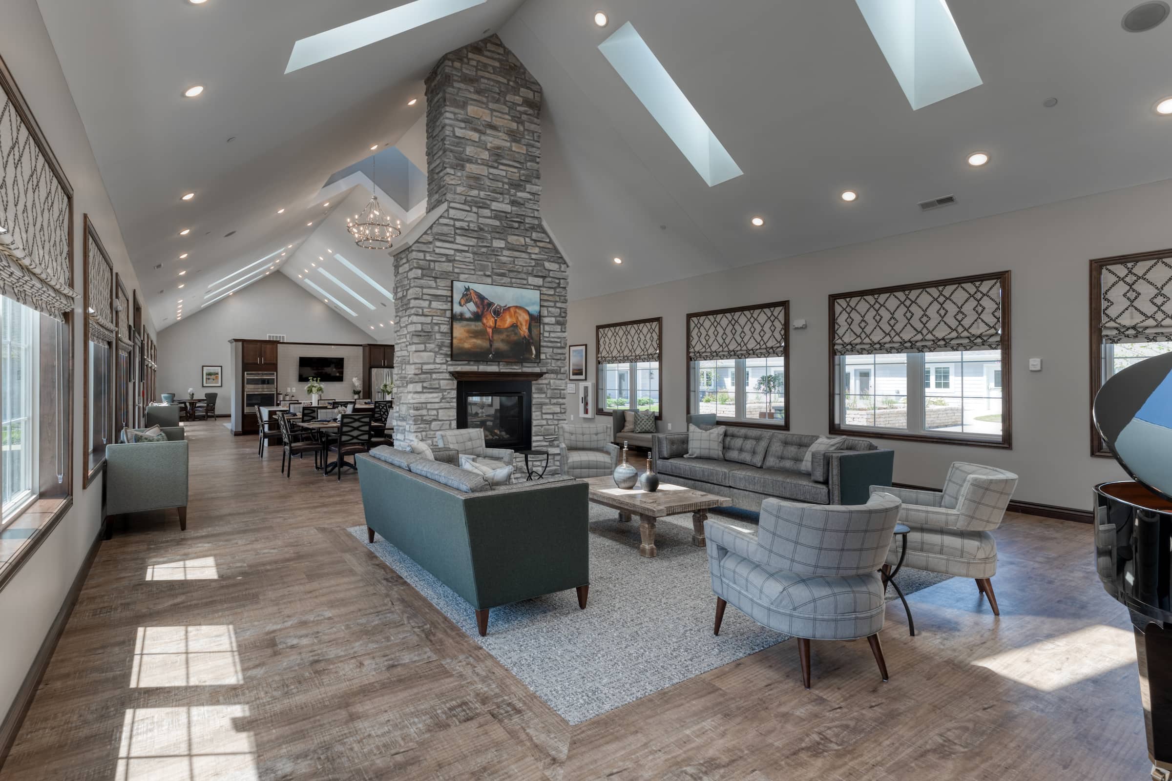 Open living room area with custom stone fireplace and abundant seating